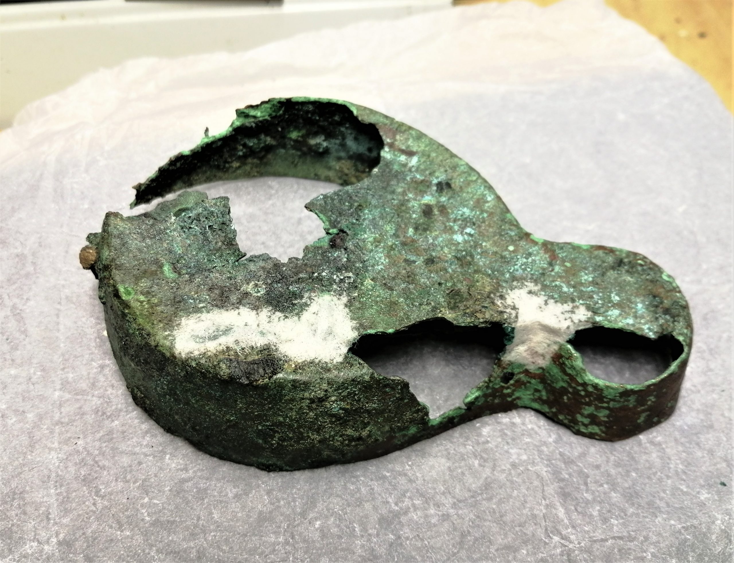 The process of infilling and colour matching on a corroded Roman bronze lamp.
